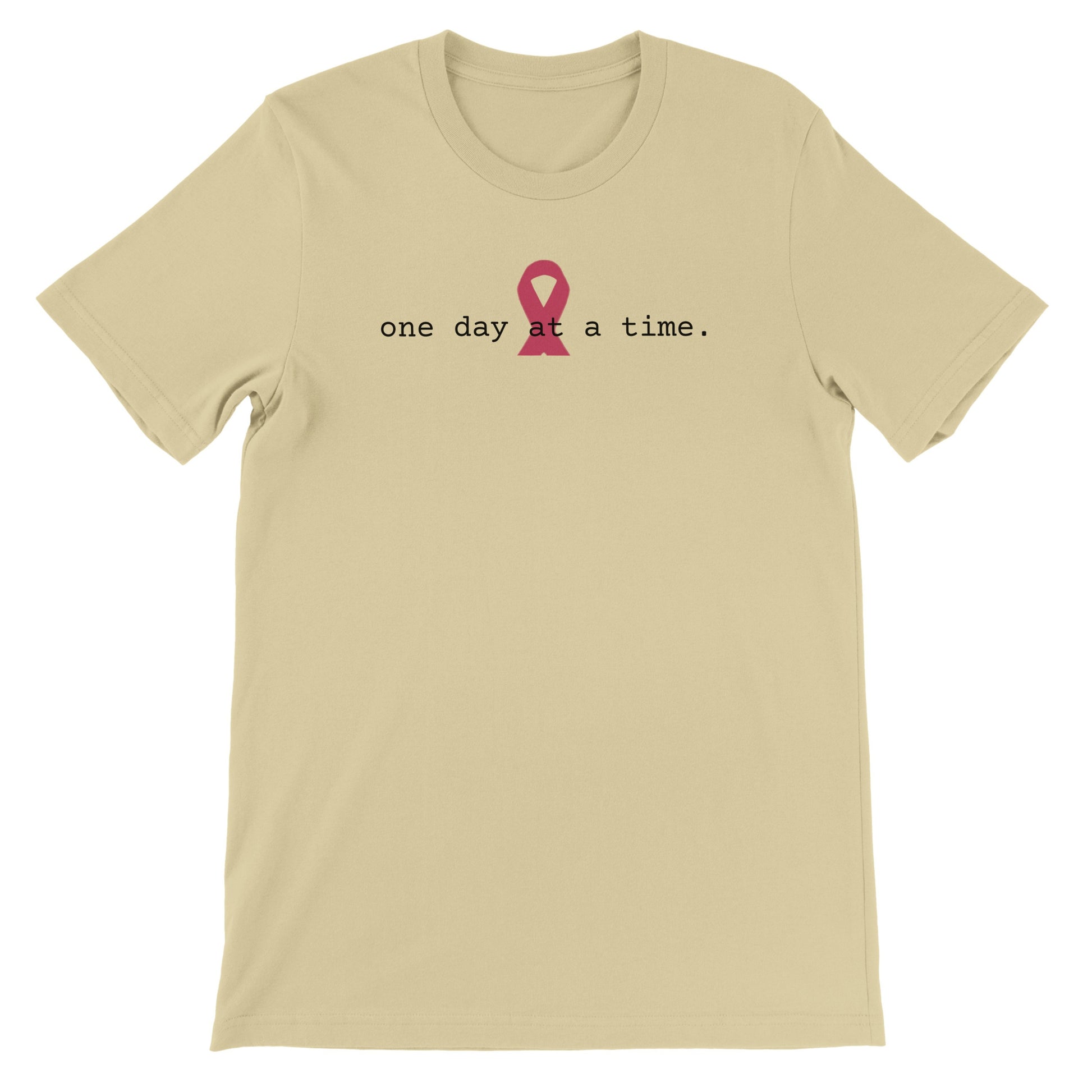 A  natural colored t-shirt with a pink awareness ribbon and the text 'one day at a time.'