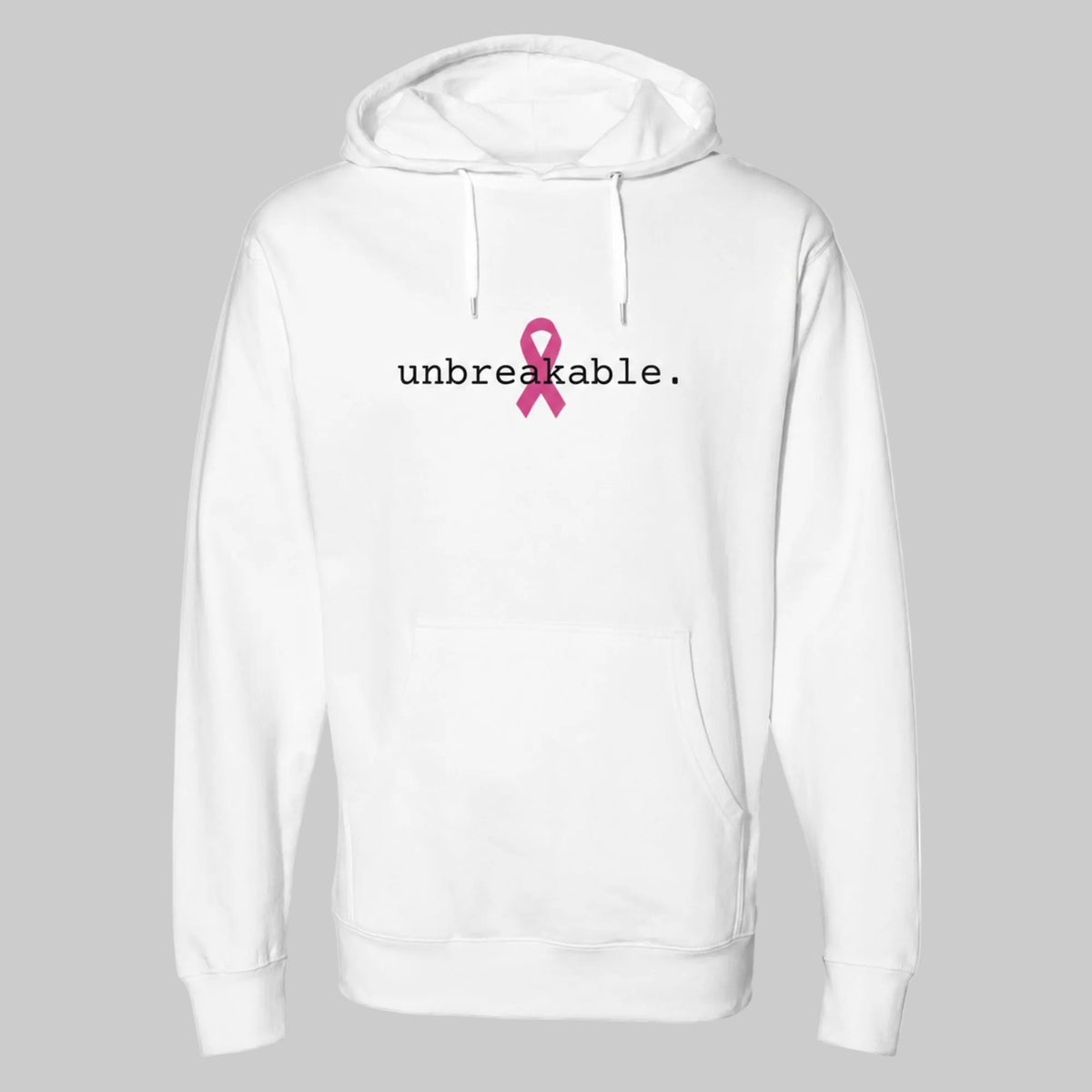 A white pullover hoodie with a front kangaroo pocket and drawstring hood, featuring the word 'unbreakable.' in black text and a pink awareness ribbon graphic on the chest on a warm grey background.