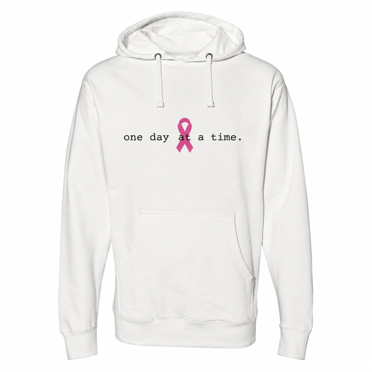 A bone pullover hoodie with a front kangaroo pocket and drawstring hood, featuring the printed text 'one day at a time.' in black next to a pink awareness ribbon on the chest.
