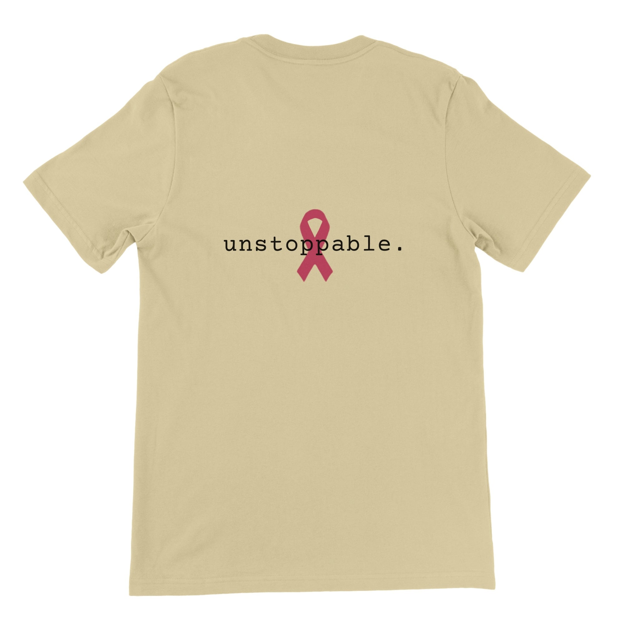 A natural-colored short-sleeve t-shirt shown from the back, featuring the word 'unstoppable.' in black lowercase letters with a pink awareness ribbon graphic in the center.